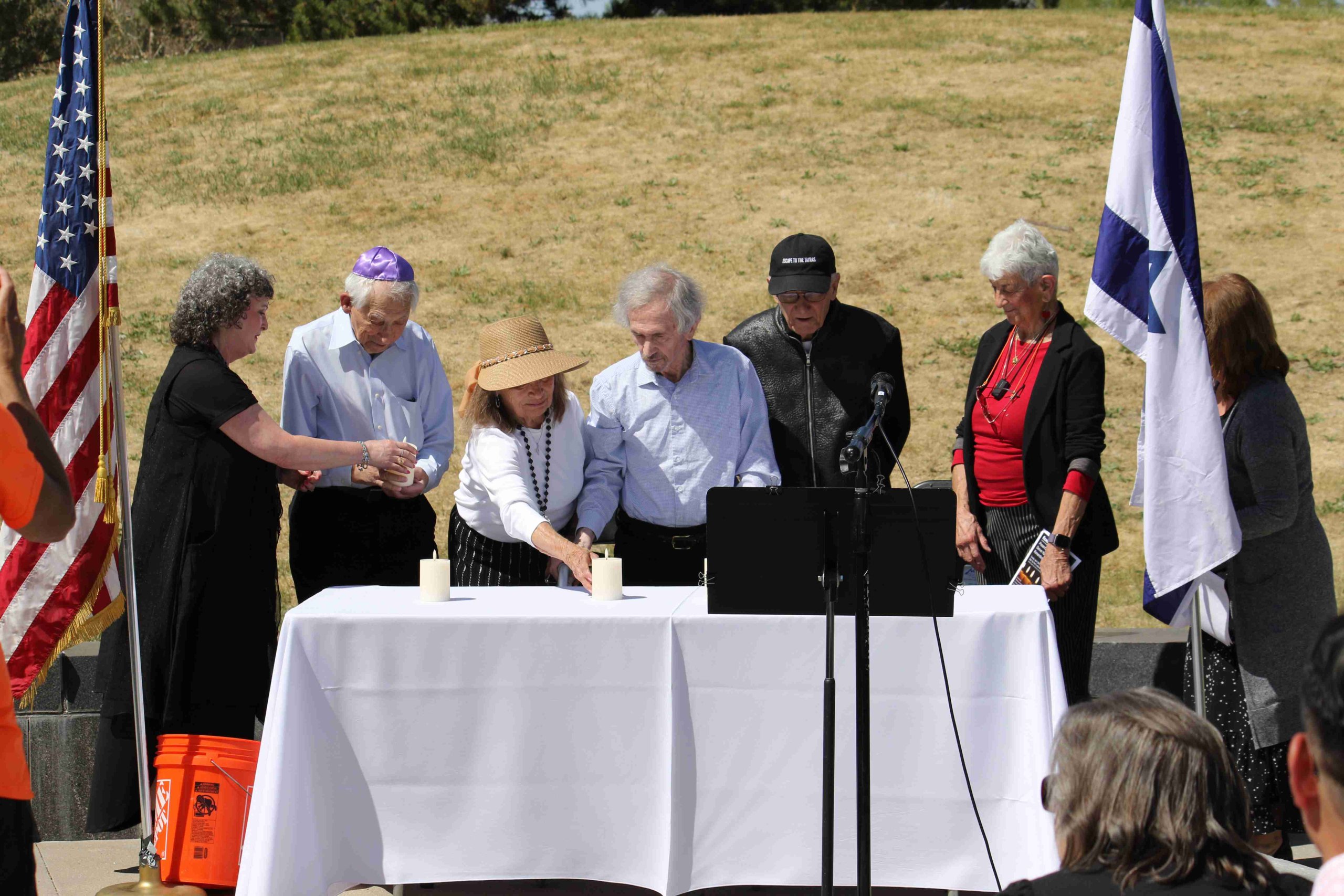 Holocaust survivors lighting memorial candles