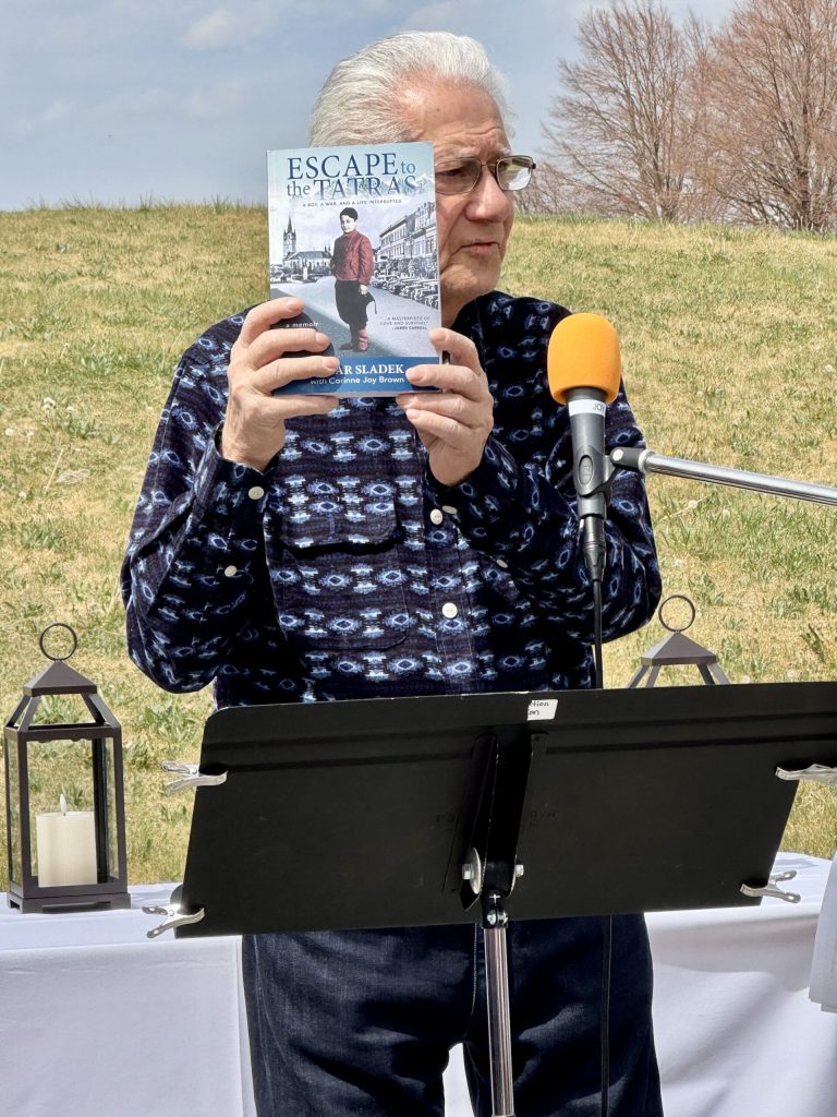 Holocaust survivor Osi Sladek with his book Escape to the Tatras